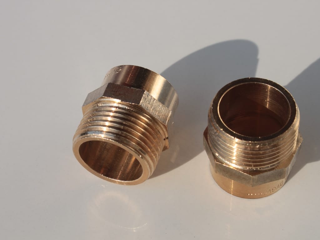 Two brass threaded adapters for copper plumbing connections